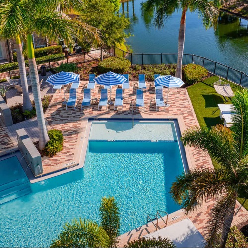 aerial shot of pool next to pond with fountain
