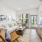 Open living room with light color couch, large windows, and patio door