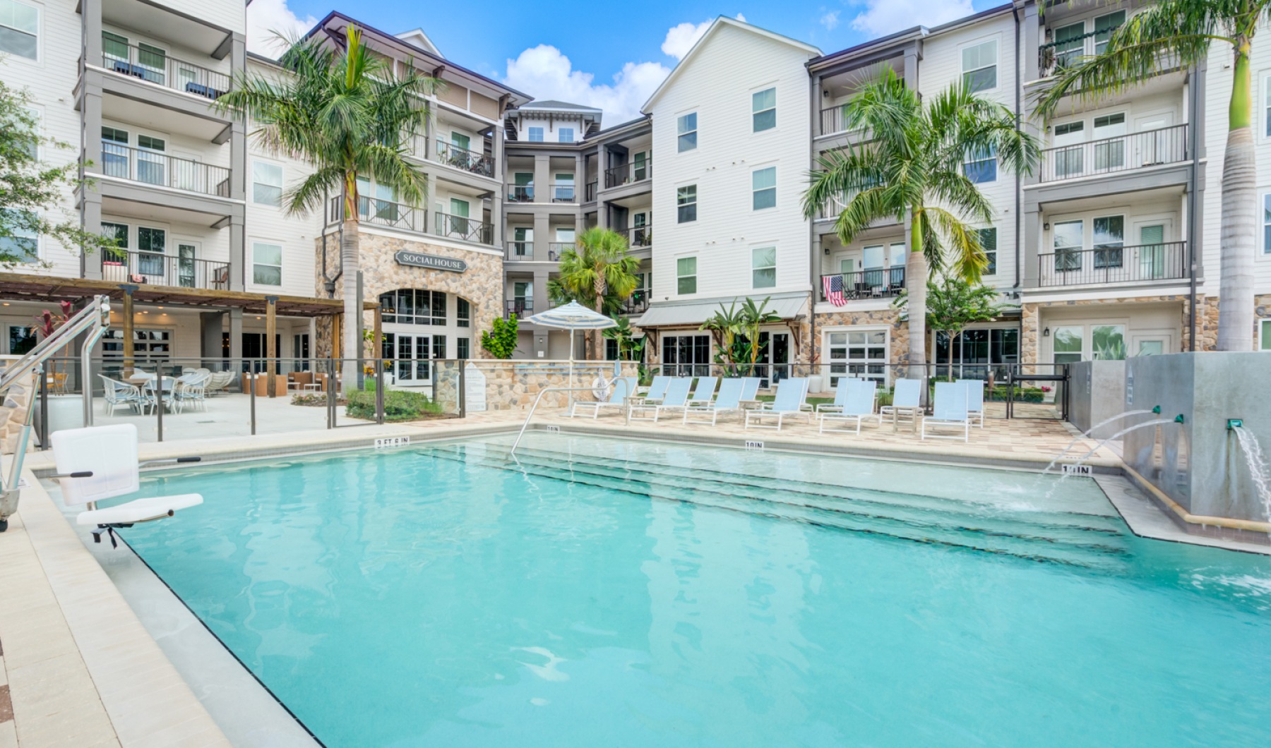 Pool area with lounge chairs and relaxing views