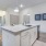 kitchen island with white cabinets and stainless steel appliances