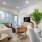 living room with a couch, chair and tv next to a plant